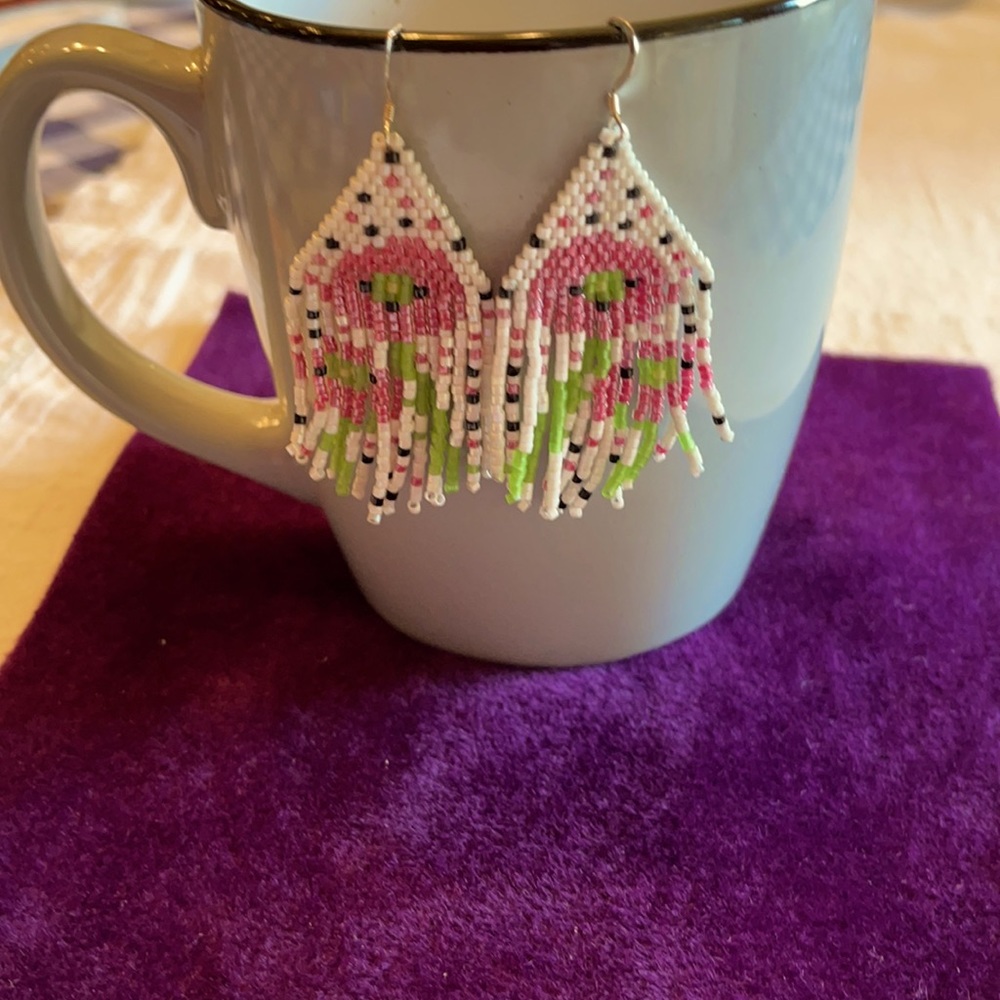 Hand beaded fringe earring.